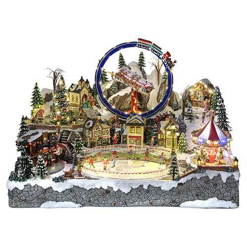 Cenário natalino Deluxe com patinadores, comboio, trenó e carrosséis 65x50x45 cm corrente eléctrica